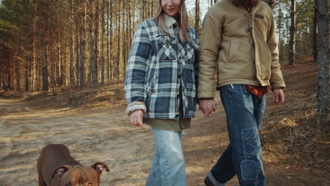 Couple-Walking-with-Dog-in-Woods